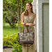 The Myra Bag Mystique Messenger Bag features upcycled woven canvas with rich leather accents. 