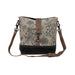 Floral print canvas bag featuring a brown strap and a brown leather shoulder strap for added style and comfort.