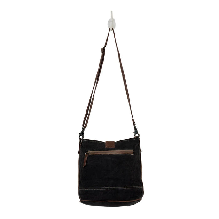 Stylish floral print canvas bag with a brown strap and a brown leather shoulder strap for comfortable carrying.