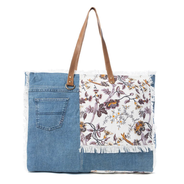 This Myra Bag Venture Weekender Bag features a vintage paisley-inspired printed canvas body in neutral gray tones. 