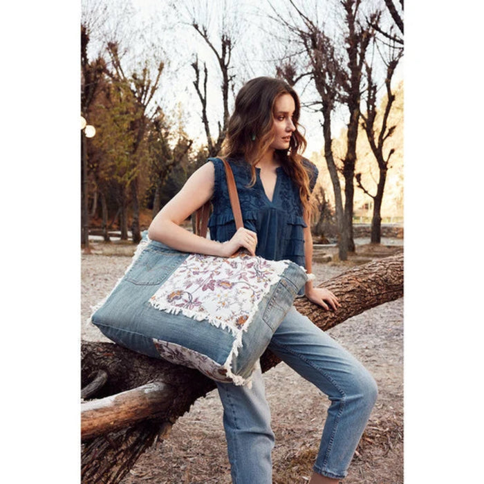 This Myra Bag Venture Weekender Bag features a vintage paisley-inspired printed canvas body in neutral gray tones. 