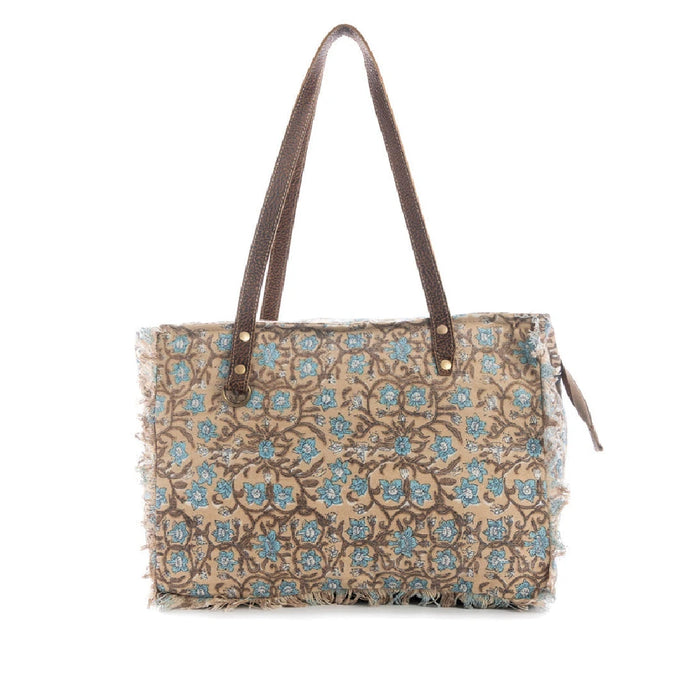 A blue and brown floral print tote bag with vibrant flowers and sturdy handles, ideal for shopping or casual outings.