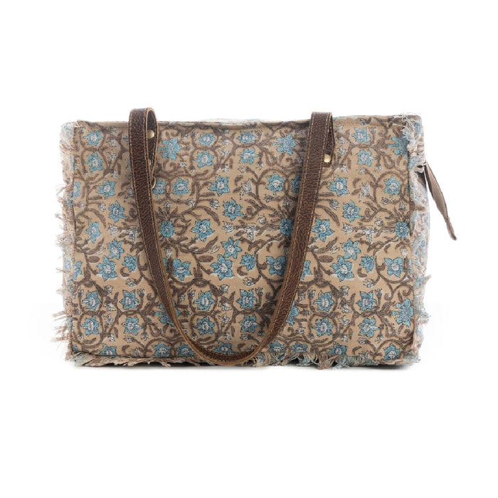 A blue and brown tote bag adorned with a floral design, combining functionality with a chic aesthetic for various occasions.