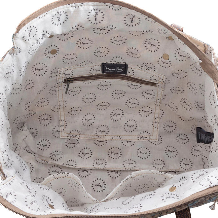 A tote bag showcasing a blue and brown floral print, offering a fashionable way to carry items while on the go.