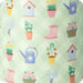 A garden-themed wine glass with a green lid, showcasing floral designs and a vibrant outdoor aesthetic.