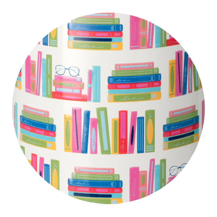 A white tumbler with a green lid, decorated with a charming book pattern, perfect for enjoying beverages while reading.
