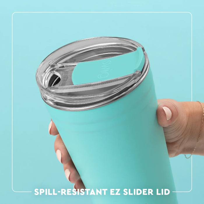 A white tumbler with a green lid, featuring a whimsical book pattern, ideal for readers who enjoy beverages on the move.