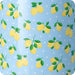 A blue mug adorned with a lively lemon pattern, adding a touch of brightness to any beverage.