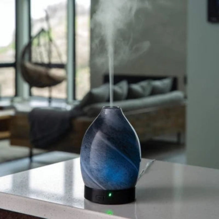 The Airomé Obsidian Medium Ultrasonic Essential Oil Diffuser by Candle Warmers uses ultrasonic technology to disperse a fine, cool mist into any room. 