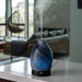 The Airomé Obsidian Medium Ultrasonic Essential Oil Diffuser by Candle Warmers uses ultrasonic technology to disperse a fine, cool mist into any room. 