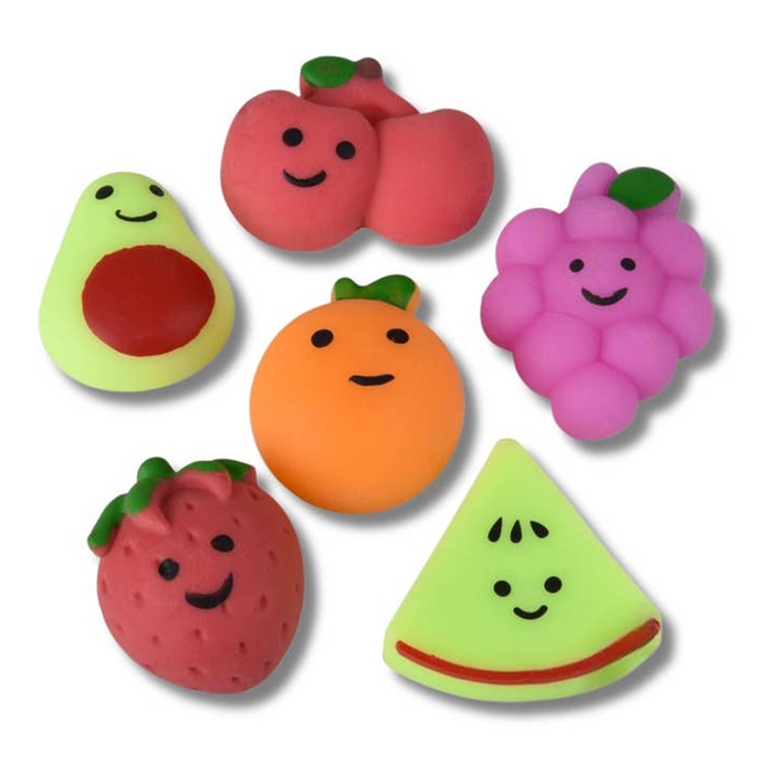 Set of colorful fruit-shaped toys on a white background