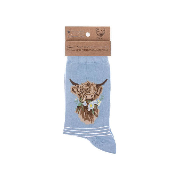 A set of blue socks showcasing a cute cow illustration.