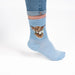  Blue socks adorned with a whimsical cow graphic.