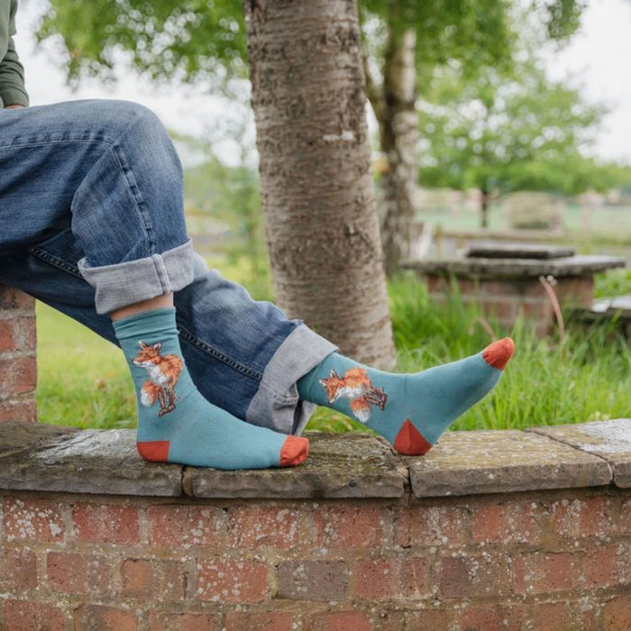 Colorful socks adorned with a whimsical fox illustration.