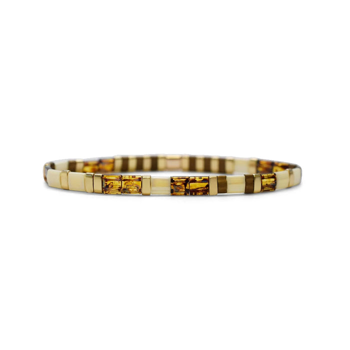 A close-up of a bracelet crafted from alternating brown and white glass beads, showcasing its unique color combination.