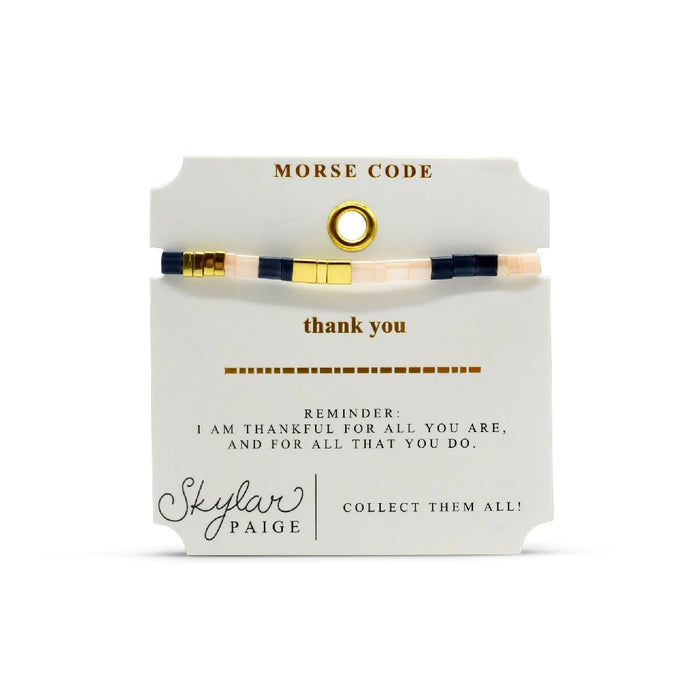 A chic bracelet made of striped fabric combined with gold-tone metal, offering a trendy accessory for various occasions.