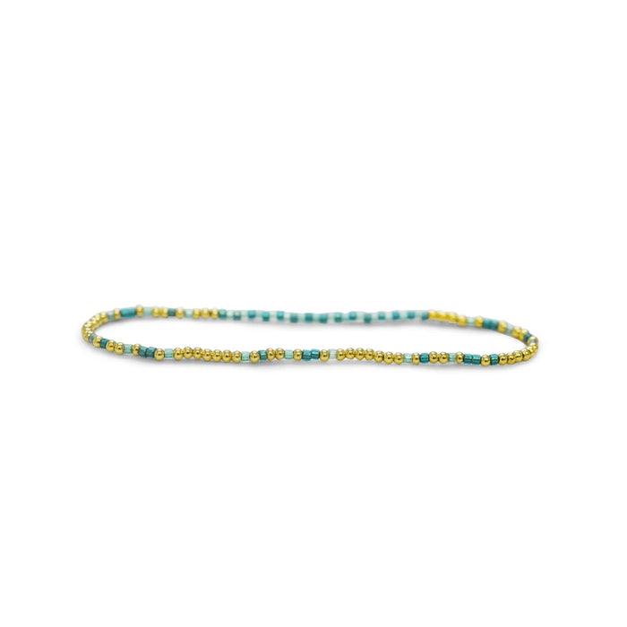 A bracelet featuring turquoise beads complemented by elegant gold accents.