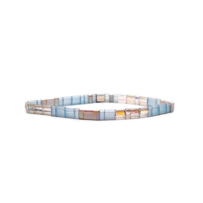 A bracelet featuring an arrangement of blue and white glass beads, showcasing a delicate and colorful design.