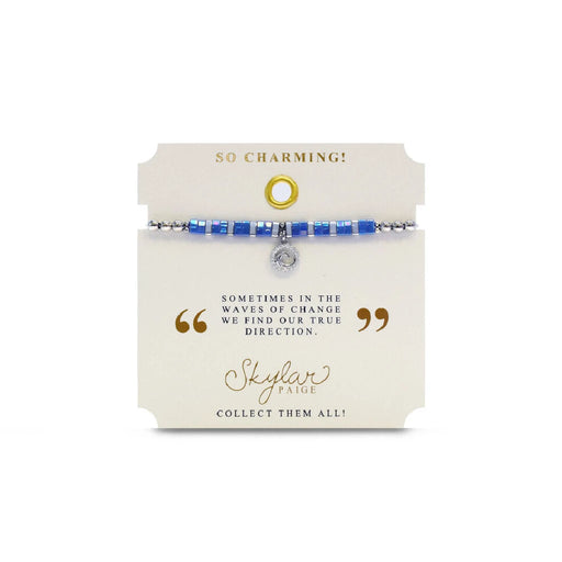A bracelet with vibrant blue stones and a delicate silver charm, showcasing a blend of elegance and charm.