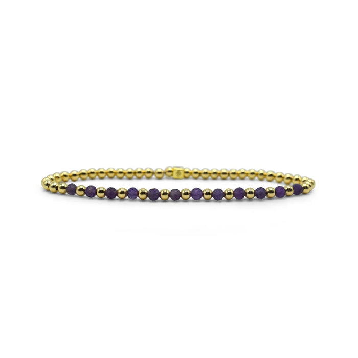 A gold bracelet embellished with purple stones, offering a sophisticated and colorful touch to any outfit.