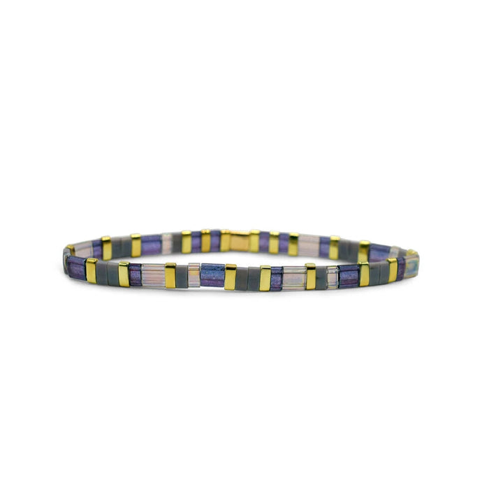 A gold bracelet adorned with several purple stones, showcasing an elegant and vibrant design.