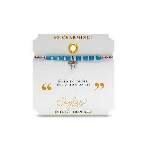 A vibrant turquoise bracelet featuring a charming bow, adding a touch of elegance to the accessory.