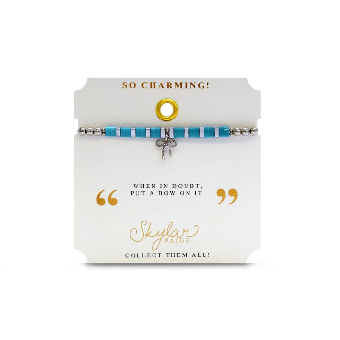A vibrant turquoise bracelet featuring a charming bow, adding a touch of elegance to the accessory.