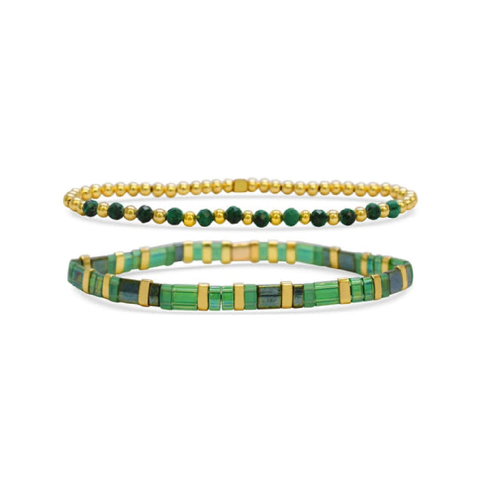  Two bracelets featuring green and gold beads arranged in a decorative pattern.
