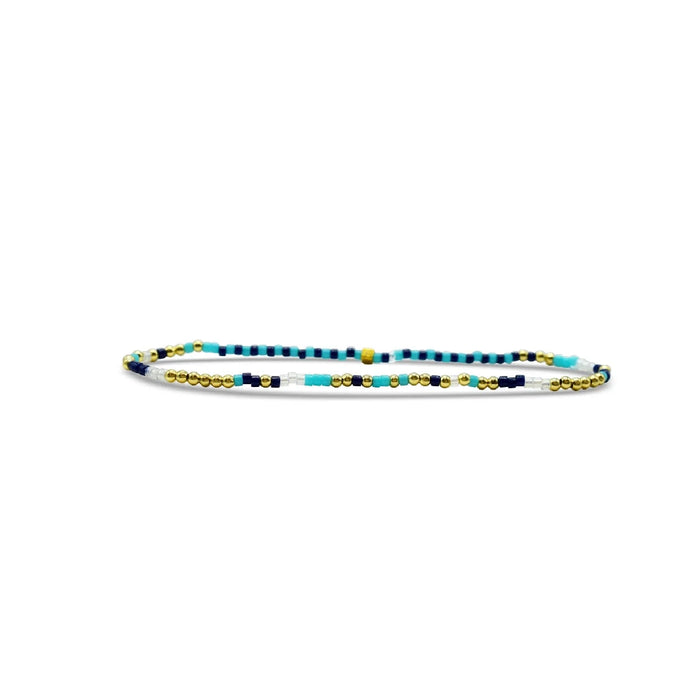 A beaded bracelet featuring a pattern of blue, yellow, and white beads arranged in a vibrant design.