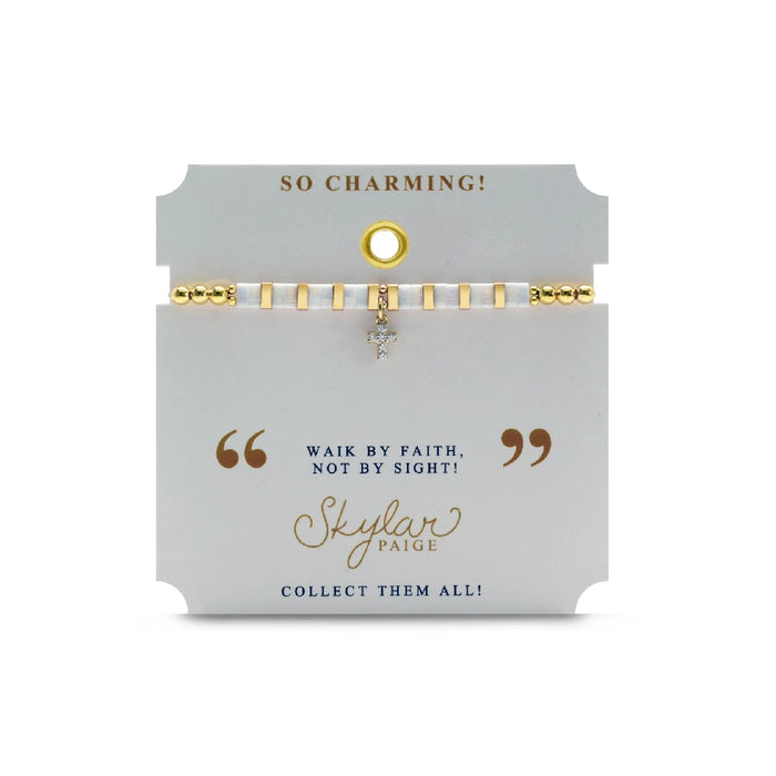 A stylish bracelet composed of gold and white beads, highlighted by a decorative cross charm.