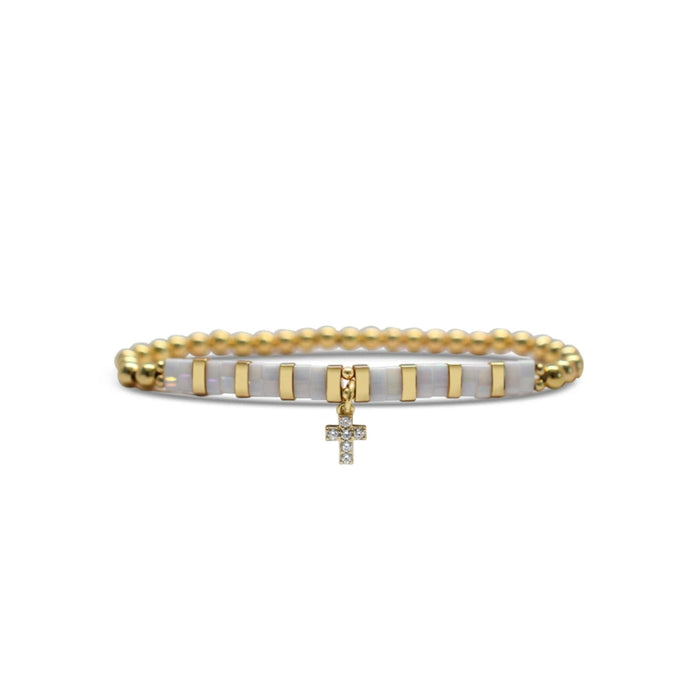  Gold and white bead bracelet featuring a cross design, elegantly crafted for a stylish accessory.