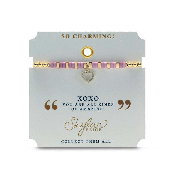 A stylish pink bracelet with a heart charm, showcasing a playful and romantic accessory for everyday wear.