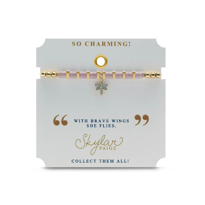 An elegant pink and gold bracelet with a dragonfly charm, combining vibrant colors and intricate detailing for a chic look.