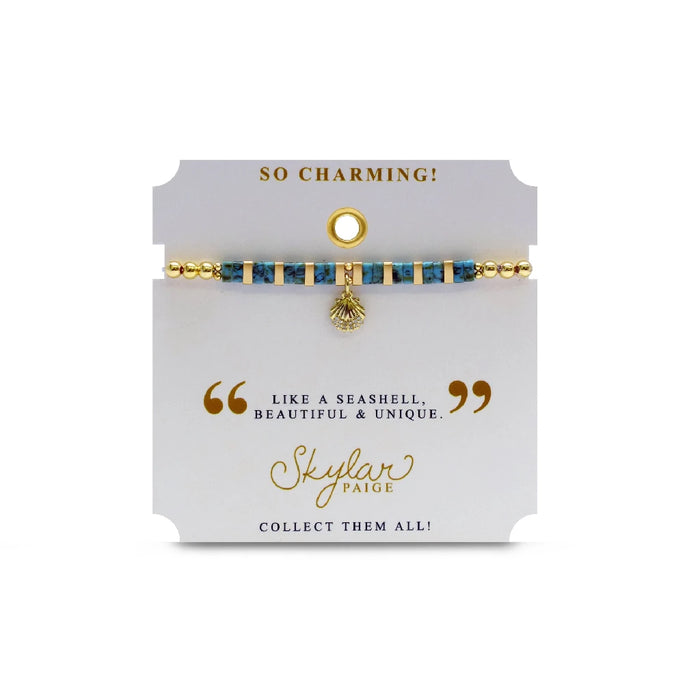 Elegant gold bracelet adorned with turquoise beads and a charming gold leaf pendant, perfect for any occasion.