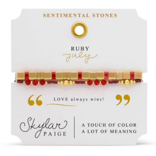 Stia Couture Sentimental Stones July birthstone bracelet featuring ruby-colored crystal accents with a gold-tone stretch beaded design in gift-ready packaging.