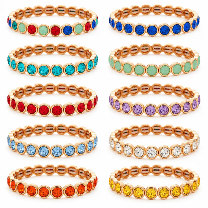 Assorted bracletes in gold on a white background 