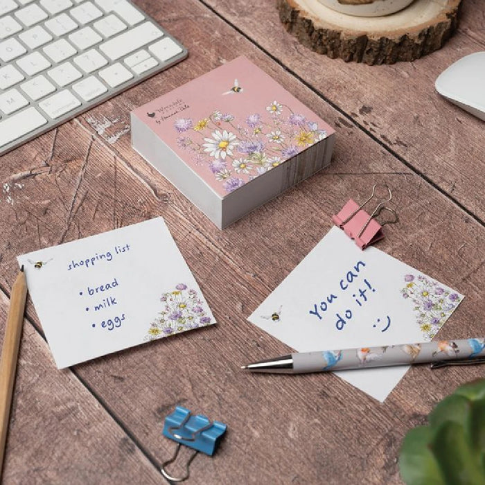 A pink notebook decorated with cheerful daisies and buzzing bees, perfect for notes and creativity.