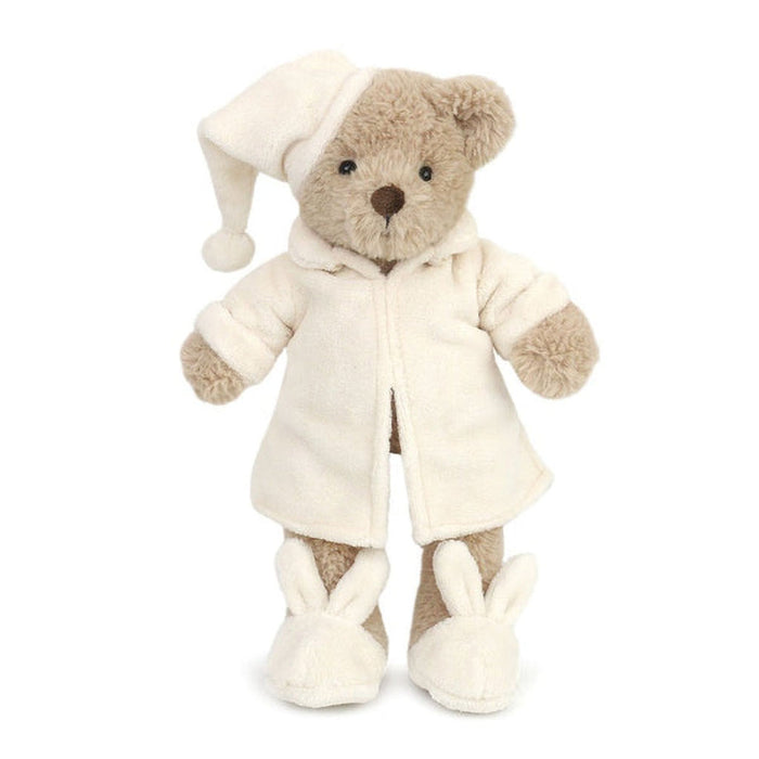 Plush teddy bear in a white outfit with a hat on a white background