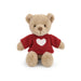 A teddy bear wearing a red sweater adorned with a heart symbol.
