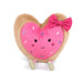 A cute pink heart-shaped plush with a bow, embodying a playful and affectionate spirit.