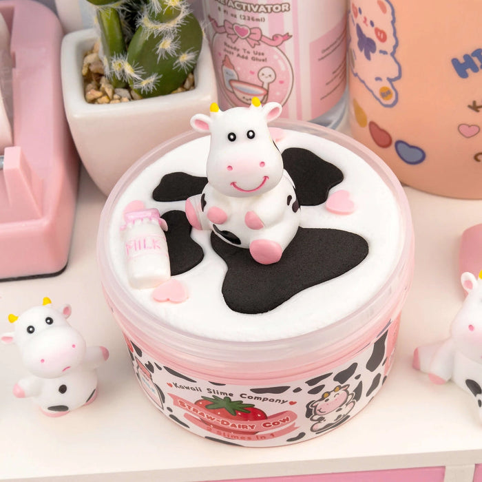 Cute cow-themed product with a small cow figure on top, surrounded by pink and white items.