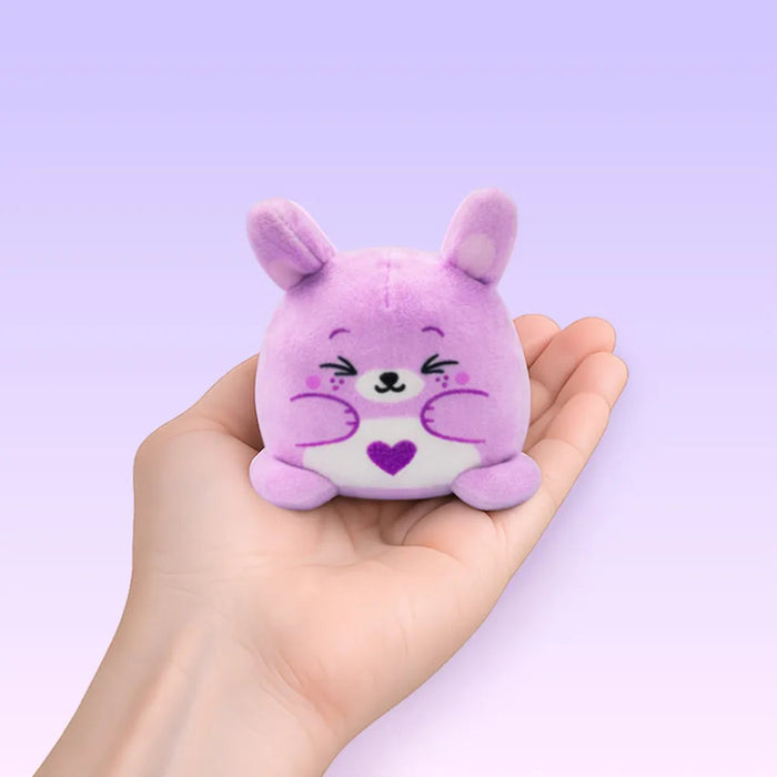 Purple plush toy with a heart on a light purple background