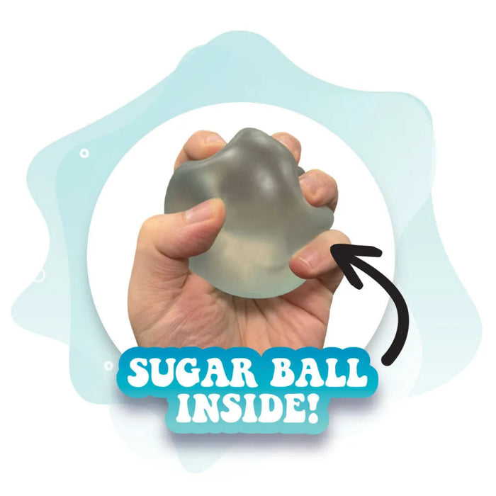 Hand holding a gray stress ball with text 'SUGAR BALL INSIDE!' on a light blue background