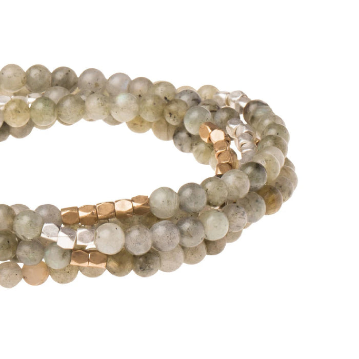 Close-up of Howlite beads bracelet with engraved silver dipped charm
