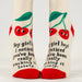 Pair of socks with cherry design and text on a white background