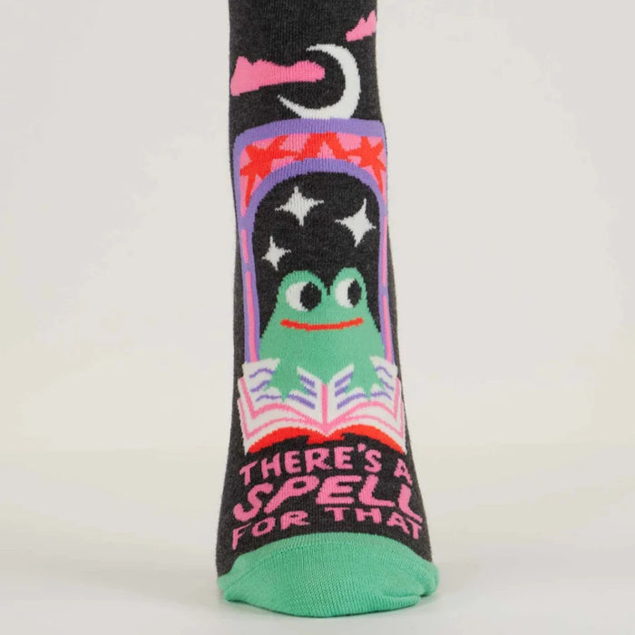 Socks with a frog design and text 'There's a spell for that' on a white background