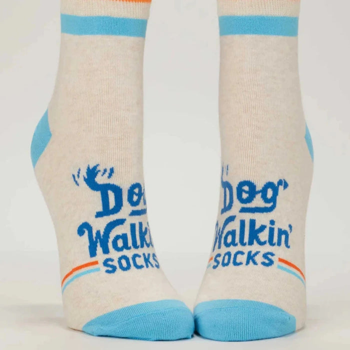 Pair of socks with 'Dog Walkin Socks' text and design on a light background