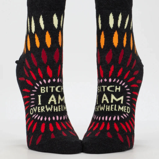 Pair of socks with colorful patterns and text on a white background