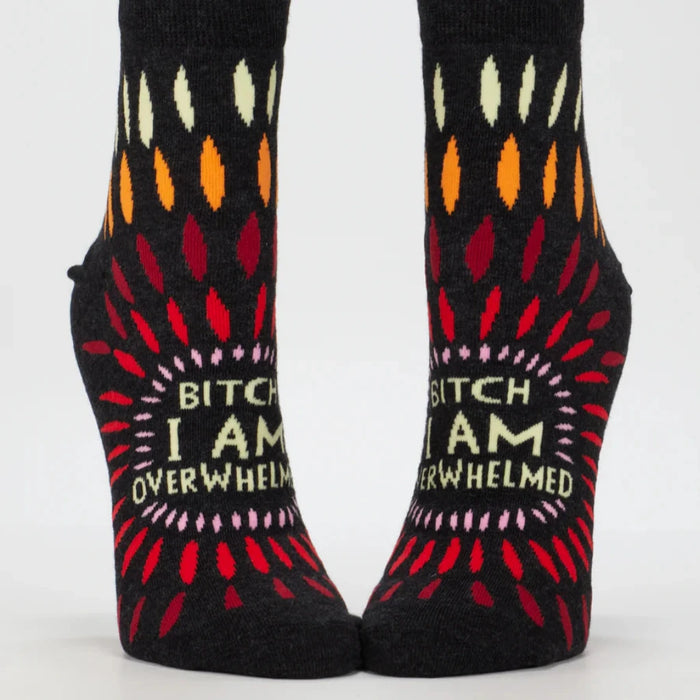 Pair of socks with colorful patterns and text on a white background