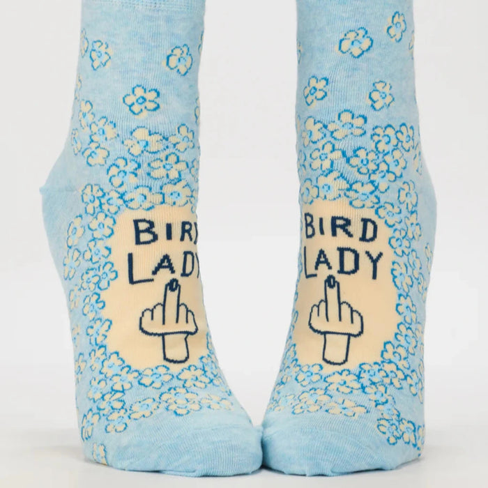 Light blue socks with floral patterns and 'Bird Lady' text on a white background